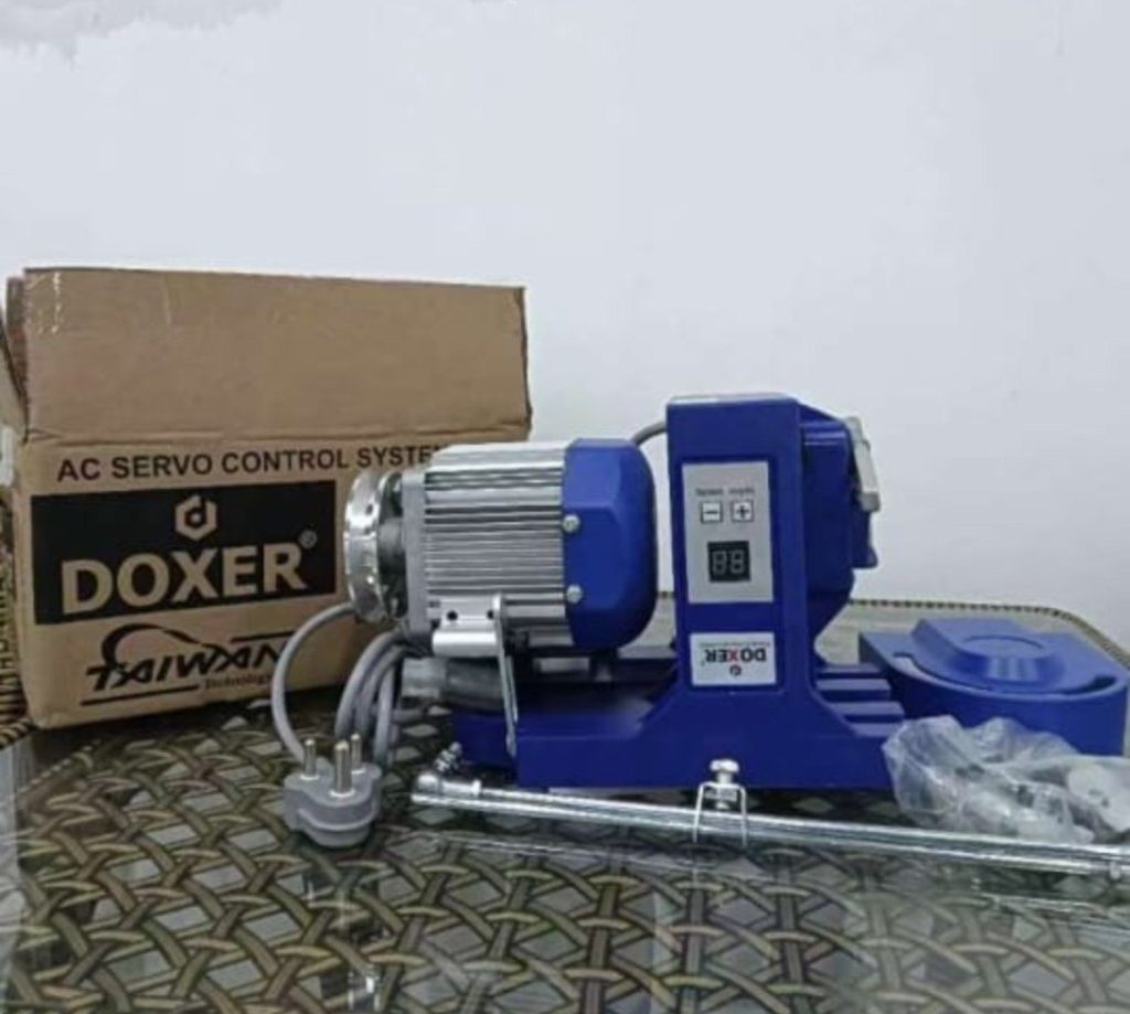 DOXER AC servo control system motor with digital panel, power plug, and sewing machine accessories placed beside branded box
